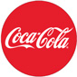 Coca-Cola logo. A red circle with white, cursive text that reads "Coca-Cola".
