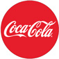 Red circle with white script coca-cola text