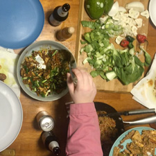 a view from able of a food preparation table with what looks like really good curry and some chopped veggies