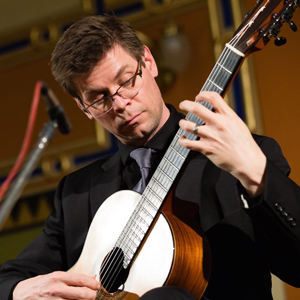 Image of Christopher Ladd playing his guitar