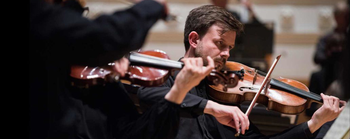 Scottish Chamber Orchestra an image of a man playing a violin.  He has light brown hair and a beard.