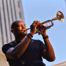 Photo of Sean Jones playing his trumpet. 