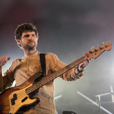 Photo of Snarky Puppy bass player performing.