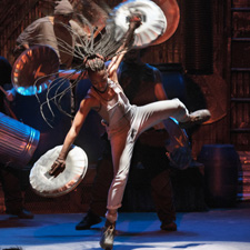 A STOMP performer mid jump.