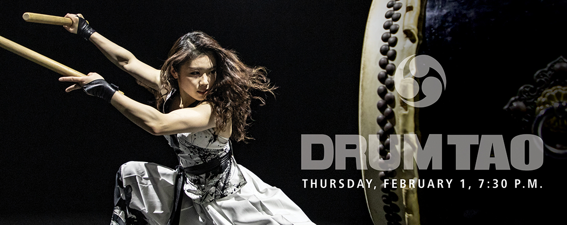 drum tao poster of a person dressed in black and white, about to strike a big drum 
