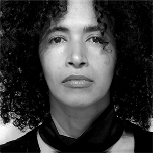 an image of Yanira Collado in black and white, looking into the camera with determination