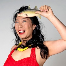 Kristina Wong headshot with fish in hand